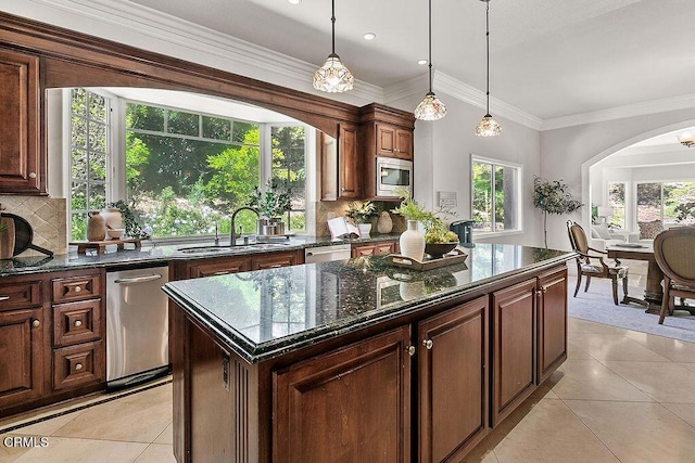 2981 Yucca Dr, Camarillo, CA 93012 - kitchen featuring stainless steel appliances, arched walkways, backsplash, light tile patterned floors, and ornamental molding