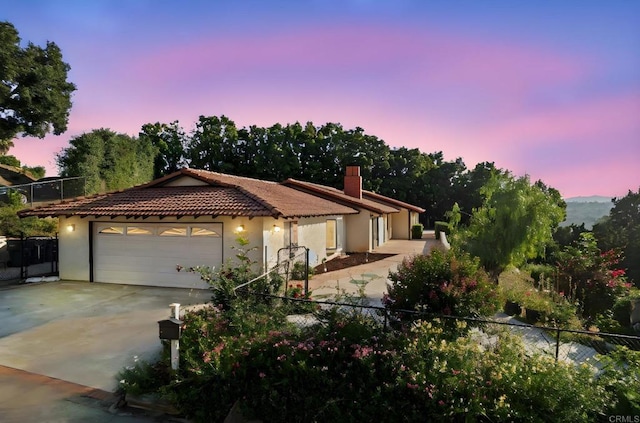 917 Gretna Green Way, Escondido, CA 92025 - mediterranean / spanish house featuring driveway, a garage, stucco siding, and a tiled roof