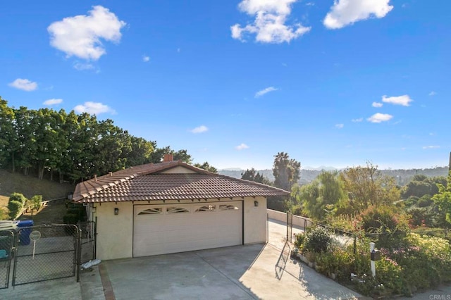 917 Gretna Green Way, Escondido, CA 92025 - view of front of house featuring a tile roof, stucco siding, a gate, and a mountain view