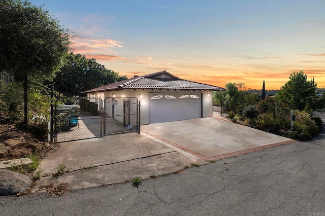 917 Gretna Green Way, Escondido, CA 92025 - view of front of house featuring a gate, a tiled roof, stucco siding, and an attached garage