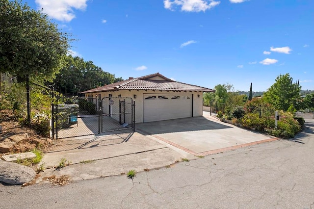 917 Gretna Green Way, Escondido, CA 92025 - ranch-style house featuring stucco siding, a tiled roof, a gate, an attached garage, and concrete driveway