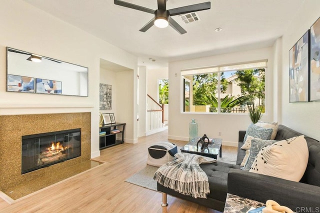 1948 Caminito De La Cruz, Chula Vista, CA 91913 - living room with wood finished floors, stairs, ceiling fan, and a premium fireplace
