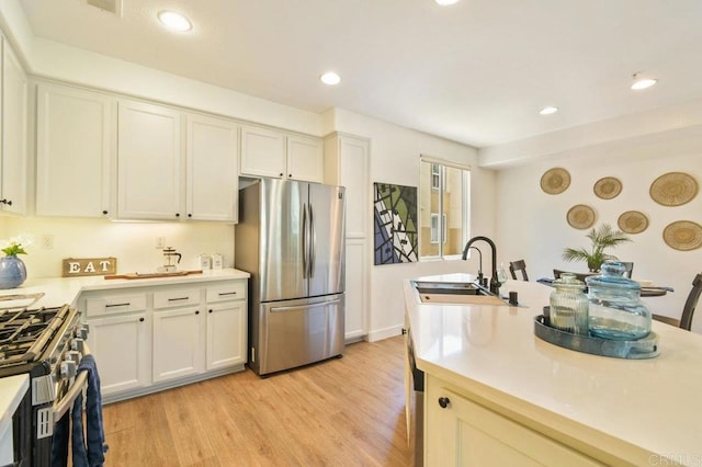 1948 Caminito De La Cruz, Chula Vista, CA 91913 - kitchen featuring stainless steel appliances, light countertops, light wood-style flooring, recessed lighting, and white cabinets