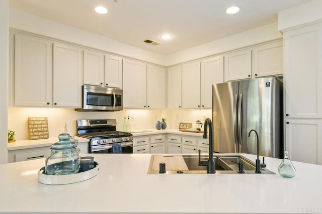 1948 Caminito De La Cruz, Chula Vista, CA 91913 - kitchen featuring appliances with stainless steel finishes, light countertops, white cabinets, and recessed lighting