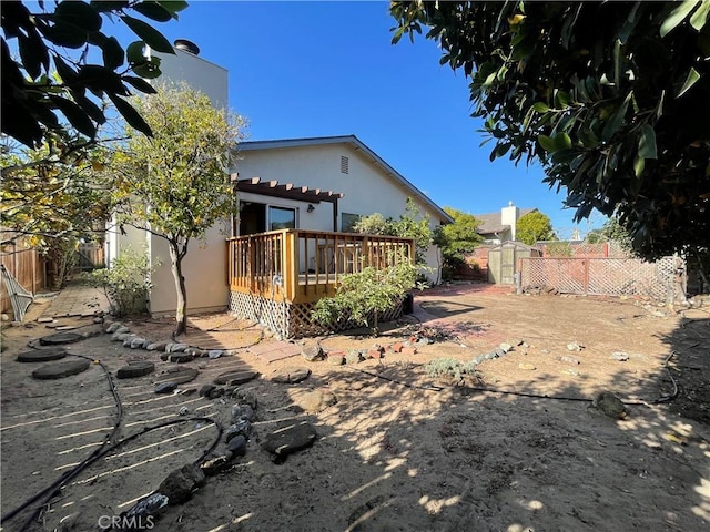 1039 Maple St, Arroyo Grande, CA 93420 - rear view of house featuring a wooden deck, a shed, a fenced backyard, and stucco siding