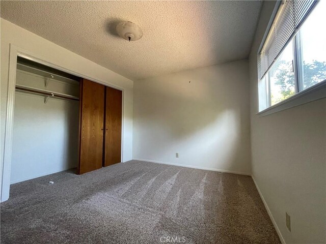 1039 Maple St, Arroyo Grande, CA 93420 - unfurnished bedroom featuring a textured ceiling, carpet flooring, and a closet