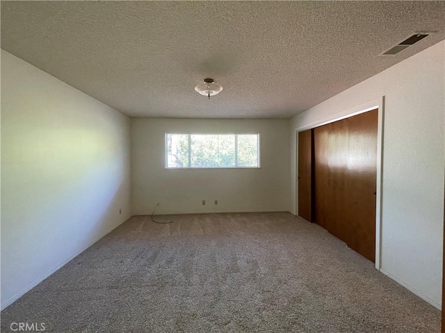 1039 Maple St, Arroyo Grande, CA 93420 - unfurnished bedroom with carpet floors, a textured ceiling, and a closet