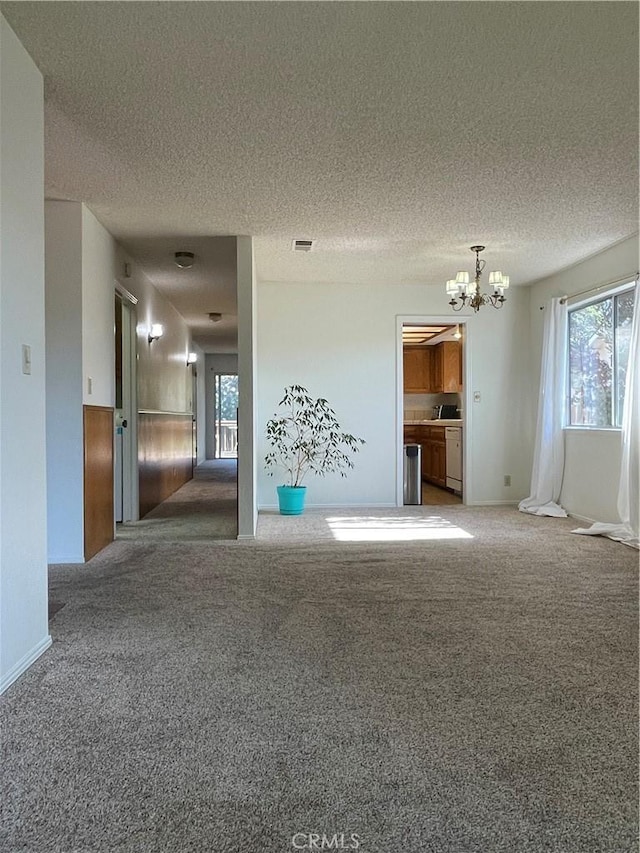 1039 Maple St, Arroyo Grande, CA 93420 - unfurnished living room featuring a chandelier, carpet flooring, and a textured ceiling