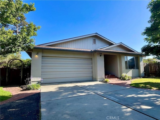 1039 Maple St, Arroyo Grande, CA 93420 - view of front of house featuring a garage, concrete driveway, and stucco siding