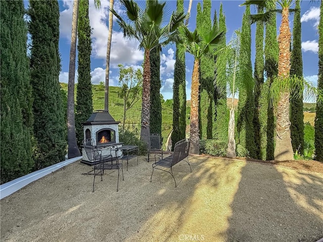 567 Lone Oak Dr, Thousand Oaks, CA 91362 - view of patio featuring a lit fireplace
