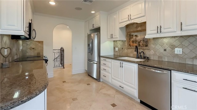 567 Lone Oak Dr, Thousand Oaks, CA 91362 - kitchen with appliances with stainless steel finishes, arched walkways, dark stone countertops, white cabinets, and recessed lighting