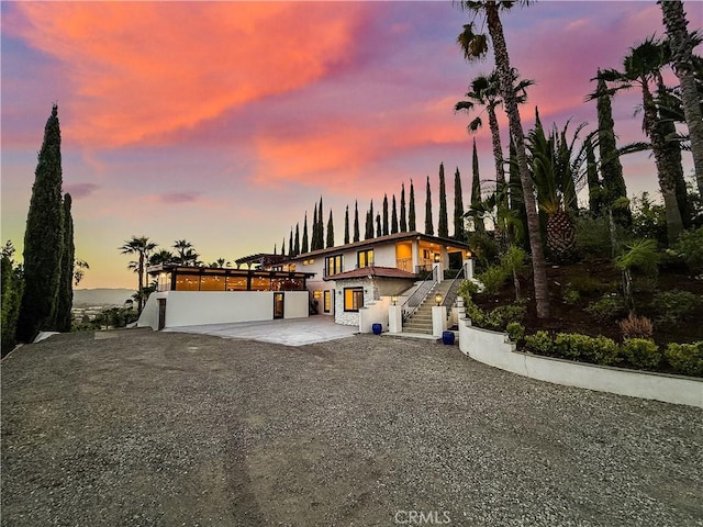567 Lone Oak Dr, Thousand Oaks, CA 91362 - modern home with stairs, a patio, stucco siding, and driveway