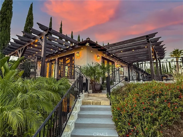 567 Lone Oak Dr, Thousand Oaks, CA 91362 - view of front facade with stairway, a pergola, and stucco siding