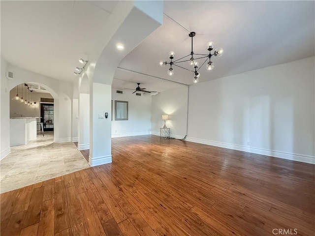 567 Lone Oak Dr, Thousand Oaks, CA 91362 - unfurnished room with a chandelier, ceiling fan, arched walkways, and wood-type flooring