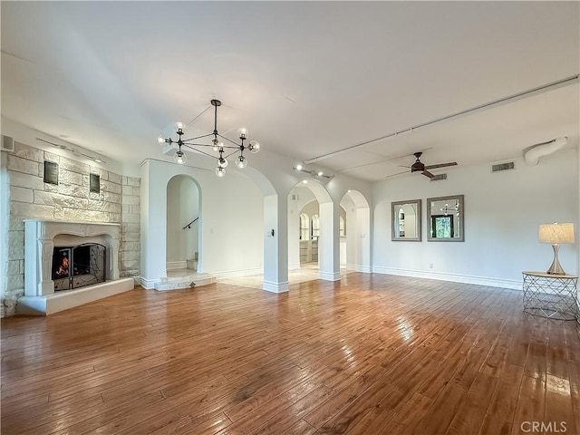 567 Lone Oak Dr, Thousand Oaks, CA 91362 - unfurnished living room featuring arched walkways, ceiling fan, hardwood / wood-style floors, and a chandelier