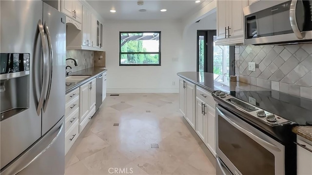 567 Lone Oak Dr, Thousand Oaks, CA 91362 - kitchen with appliances with stainless steel finishes, light flooring, tasteful backsplash, white cabinets, and recessed lighting