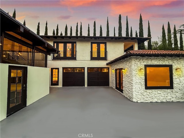 567 Lone Oak Dr, Thousand Oaks, CA 91362 - view of front of house with an attached garage, stucco siding, stone siding, driveway, and a balcony