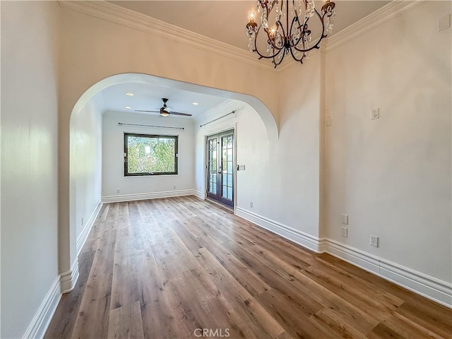 567 Lone Oak Dr, Thousand Oaks, CA 91362 - spare room with arched walkways, crown molding, wood finished floors, ceiling fan, and a chandelier