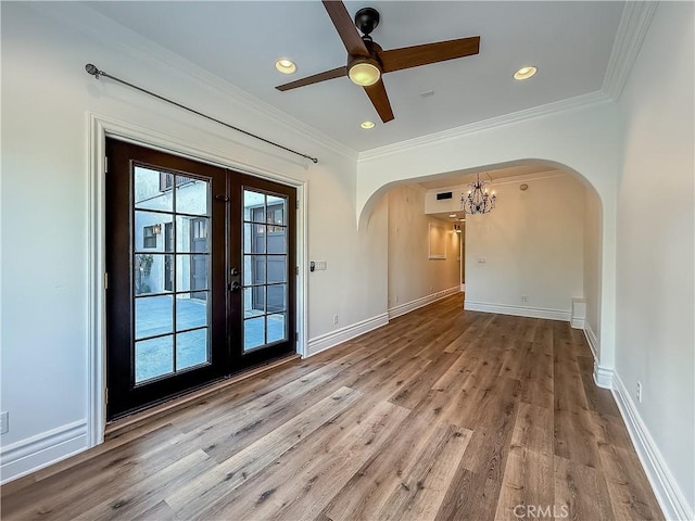 567 Lone Oak Dr, Thousand Oaks, CA 91362 - spare room featuring arched walkways, a chandelier, wood finished floors, ceiling fan, and ornamental molding
