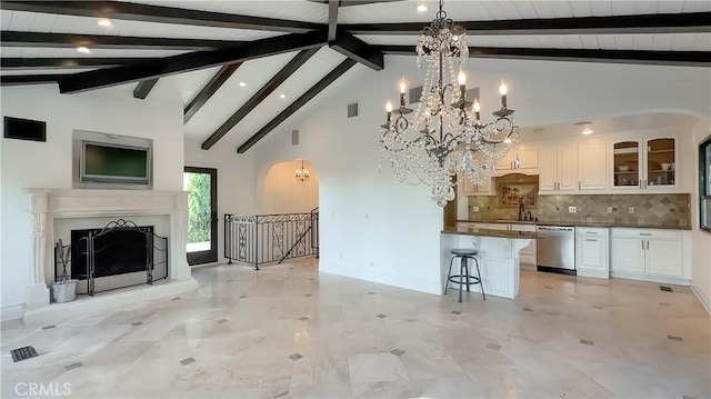 567 Lone Oak Dr, Thousand Oaks, CA 91362 - kitchen featuring stainless steel dishwasher, open floor plan, a kitchen breakfast bar, dark countertops, and white cabinetry
