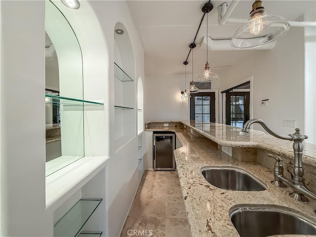 567 Lone Oak Dr, Thousand Oaks, CA 91362 - kitchen featuring pendant lighting, arched walkways, light stone countertops, and wine cooler