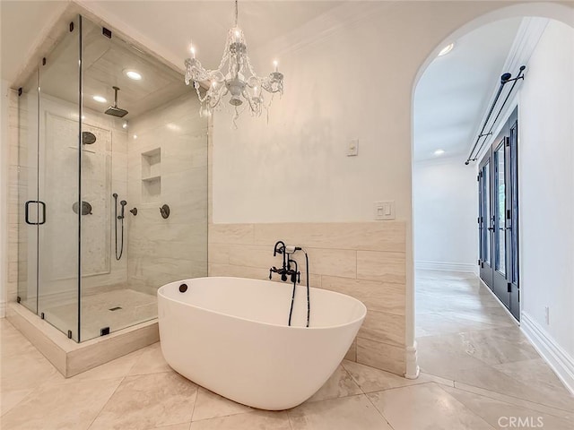 567 Lone Oak Dr, Thousand Oaks, CA 91362 - bathroom featuring a shower stall, a soaking tub, recessed lighting, crown molding, and tile walls