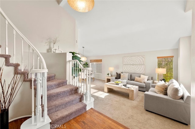 41024 Montelena Cir, Temecula, CA 92591 - living area featuring stairs, wood finished floors, carpet floors, and high vaulted ceiling