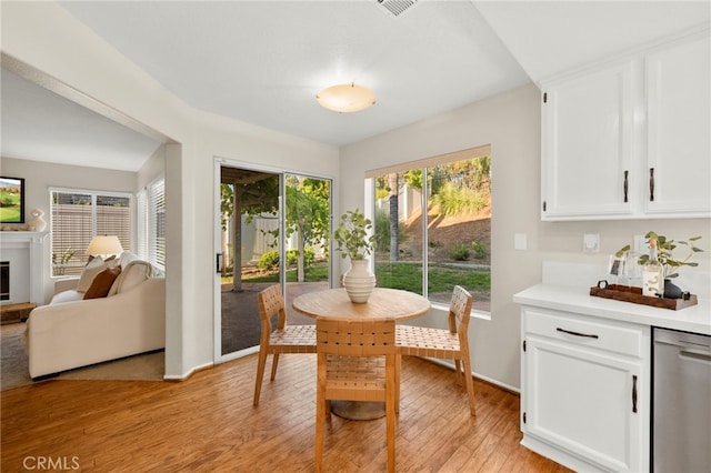 41024 Montelena Cir, Temecula, CA 92591 - dining space featuring light wood-type flooring and a glass covered fireplace
