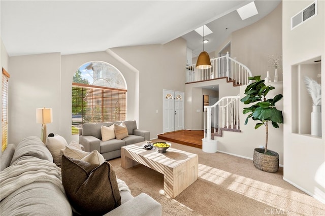 41024 Montelena Cir, Temecula, CA 92591 - carpeted living room with a skylight, stairs, and high vaulted ceiling