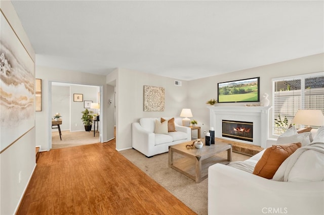 41024 Montelena Cir, Temecula, CA 92591 - living area featuring a glass covered fireplace and baseboards