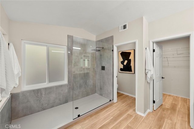 41024 Montelena Cir, Temecula, CA 92591 - bathroom featuring a tile shower, wood finished floors, and a spacious closet