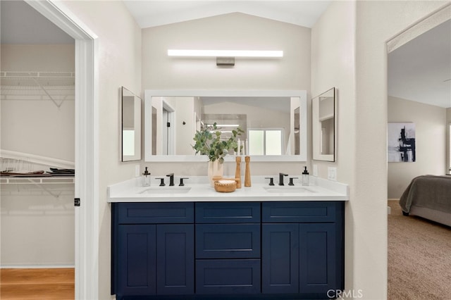 41024 Montelena Cir, Temecula, CA 92591 - ensuite bathroom featuring vaulted ceiling, double vanity, and a spacious closet