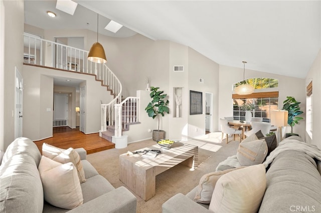 41024 Montelena Cir, Temecula, CA 92591 - carpeted living room with high vaulted ceiling, stairway, and a skylight