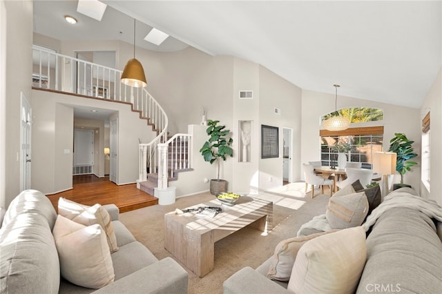 41024 Montelena Cir, Temecula, CA 92591 - carpeted living area with high vaulted ceiling, stairs, and a skylight
