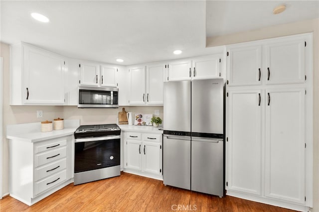 41024 Montelena Cir, Temecula, CA 92591 - kitchen featuring stainless steel appliances, light countertops, white cabinetry, light wood-type flooring, and recessed lighting