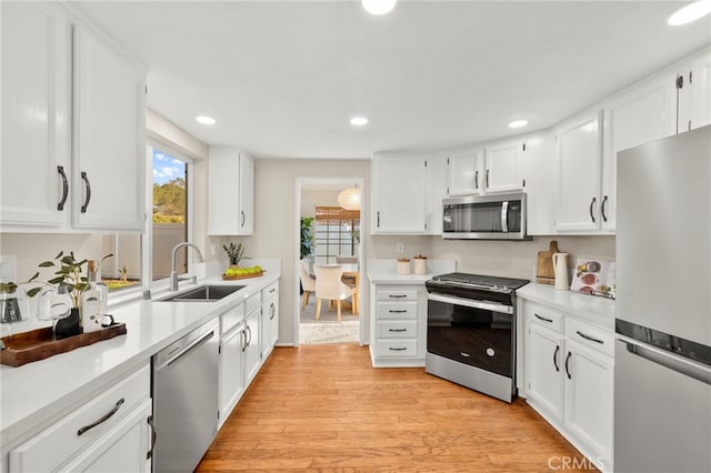 41024 Montelena Cir, Temecula, CA 92591 - kitchen with appliances with stainless steel finishes, light countertops, white cabinetry, and recessed lighting