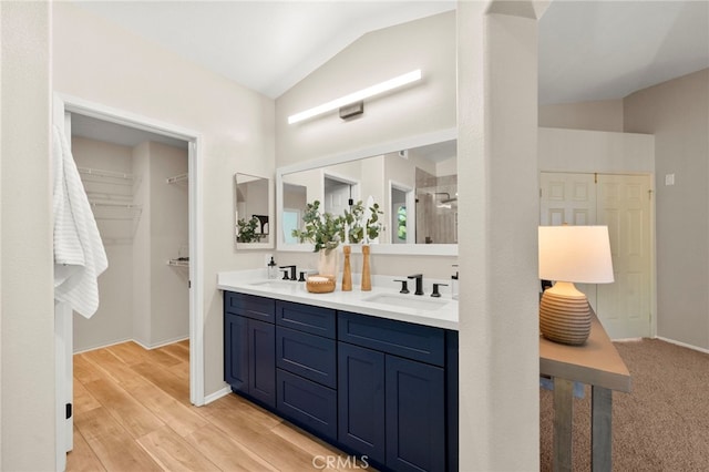 41024 Montelena Cir, Temecula, CA 92591 - full bath featuring vaulted ceiling, double vanity, wood finished floors, a shower, and a walk in closet