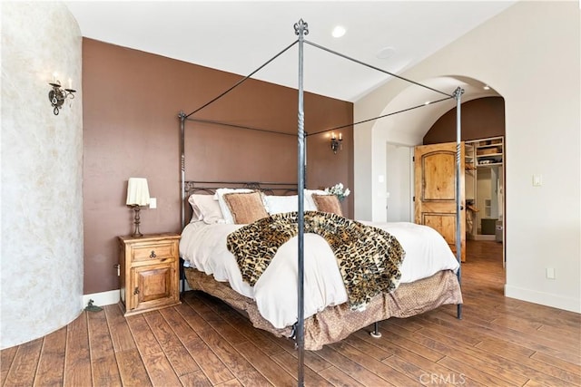 9942 Sunfish Cir, Paso Robles, CA 93446 - bedroom featuring hardwood / wood-style floors, arched walkways, and a spacious closet