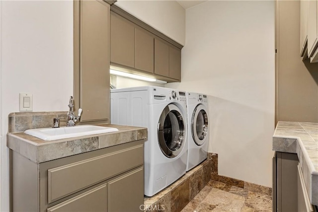 9942 Sunfish Cir, Paso Robles, CA 93446 - washroom featuring cabinet space, washing machine and clothes dryer, and stone tile flooring