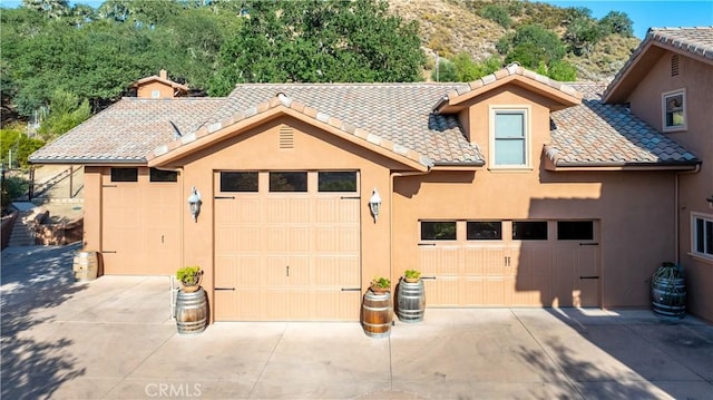 9942 Sunfish Cir, Paso Robles, CA 93446 - view of front of house featuring stucco siding, a tiled roof, and driveway