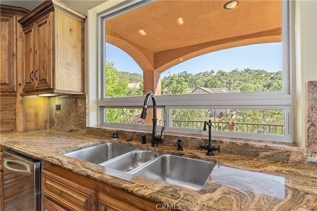 9942 Sunfish Cir, Paso Robles, CA 93446 - kitchen featuring brown cabinetry, light stone counters, decorative backsplash, and recessed lighting