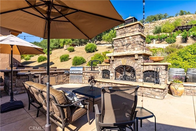 9942 Sunfish Cir, Paso Robles, CA 93446 - view of patio featuring an outdoor stone fireplace, outdoor dining area, and exterior kitchen