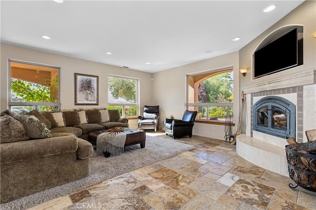 9942 Sunfish Cir, Paso Robles, CA 93446 - living area featuring a tile fireplace, stone tile flooring, and recessed lighting