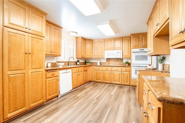 6772 Rook Dr, Huntington Beach, CA 92647 - kitchen featuring white appliances, light wood-style flooring, light stone counters, and light brown cabinets