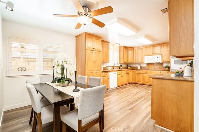 6772 Rook Dr, Huntington Beach, CA 92647 - kitchen with white appliances, light brown cabinetry, light wood-style floors, and a ceiling fan