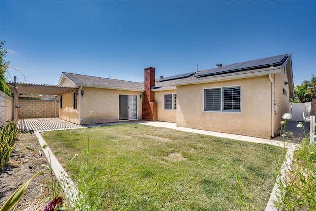 6772 Rook Dr, Huntington Beach, CA 92647 - back of house with a patio, stucco siding, roof mounted solar panels, a fenced backyard, and a pergola