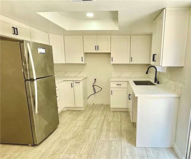 1540 Potrero Grande Dr Unit A, Rosemead, CA 91770 - kitchen with freestanding refrigerator, a tray ceiling, white cabinetry, and light stone countertops