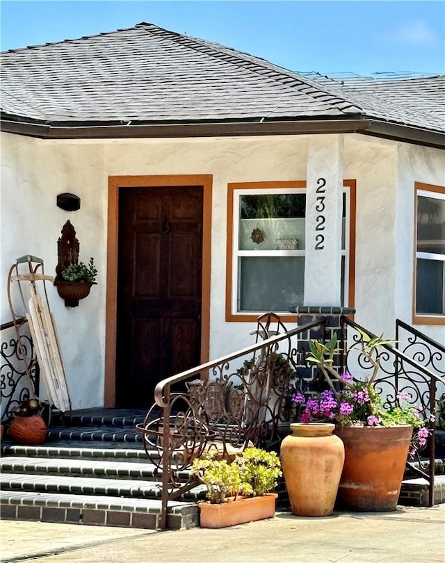 2322 249th St, Lomita, CA 90717 - view of exterior entry with roof with shingles, covered porch, and stucco siding