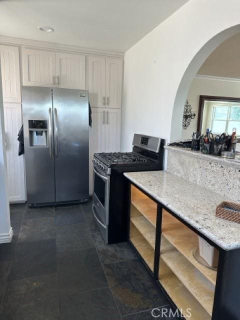 2322 249th St, Lomita, CA 90717 - kitchen with stainless steel appliances, arched walkways, white cabinets, light stone counters, and open shelves