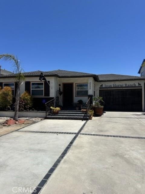 2322 249th St, Lomita, CA 90717 - view of front of property with driveway, an attached garage, and stucco siding